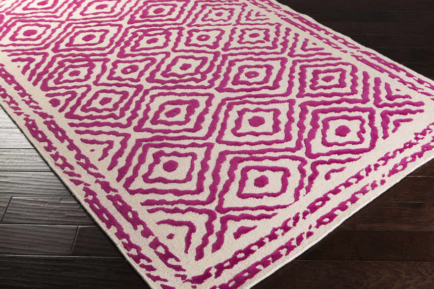 Close-up of Westhill Area Carpet. Hand-knotted wool rug in fuchsia and light beige with a geometric square pattern. Corner