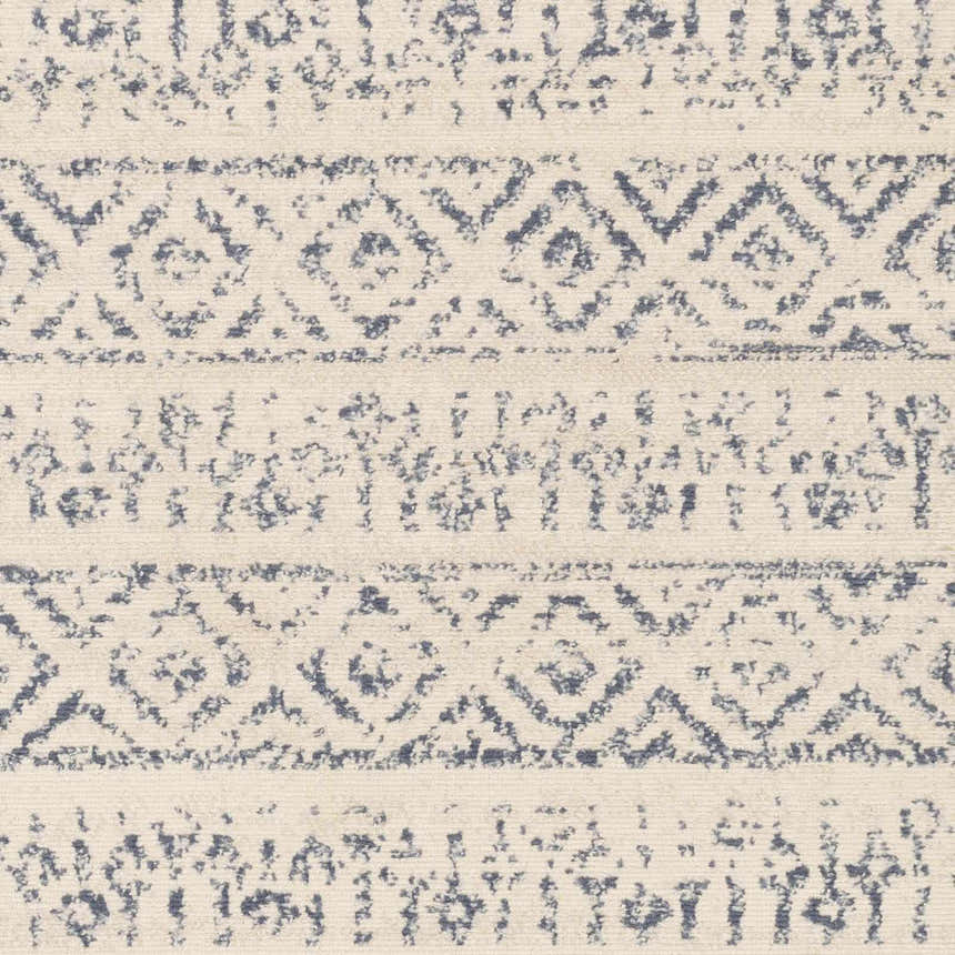 Close-up of the Westborough Beige Area Rug, featuring a contemporary geometric pattern in beige, cream, and blue. Swatch