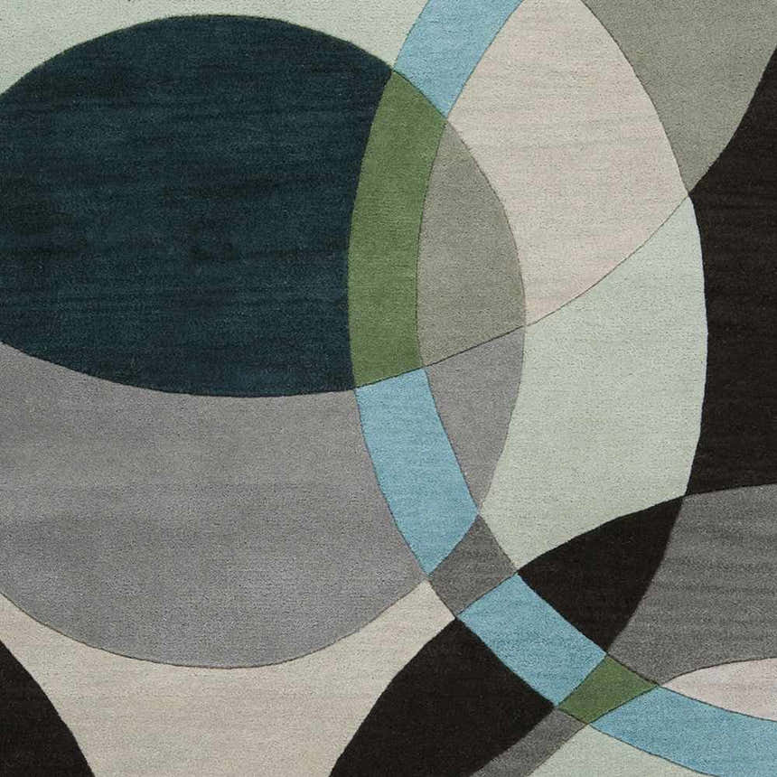 Close-up of the Wyocena Wool Rug. Features a contemporary geometric pattern in aqua, black, gray, and green hues. Swatch