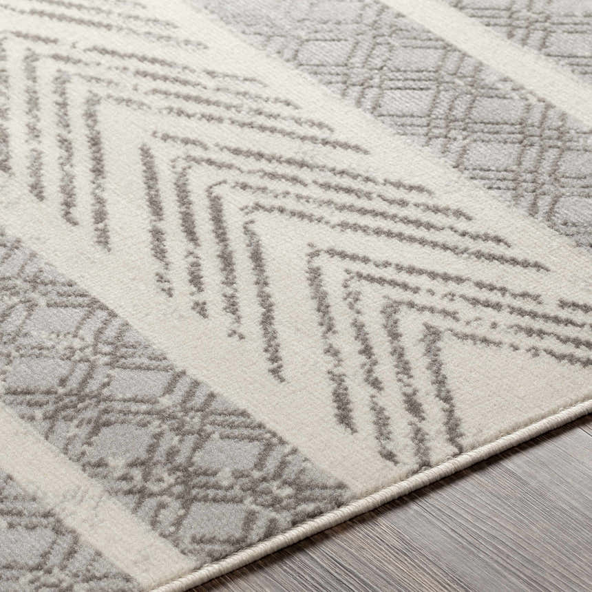 Close-up of the Wyoming Area Rug showing its gray, off-white, and charcoal bohemian-inspired geometric pattern. Texture