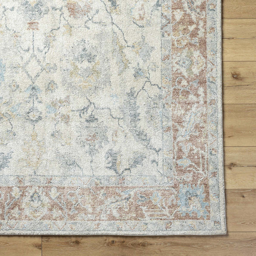 Close up of the Yetta Beige Thick Luxe Area Rug showing its traditional floral pattern and soft, neutral colors. Corner