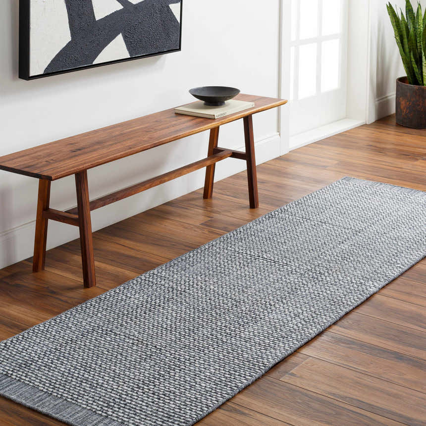 Entryway with Hand Loomed Light Gray Area Rug, wood bench, and modern art. Roomscene-Runner