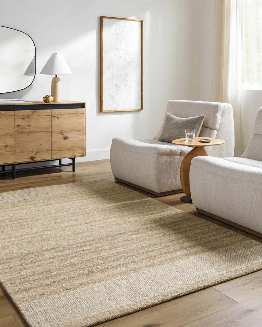 Living room scene with a neutral Yosef Area Rug, light furniture, and wood accents. Roomscene-Rectangle