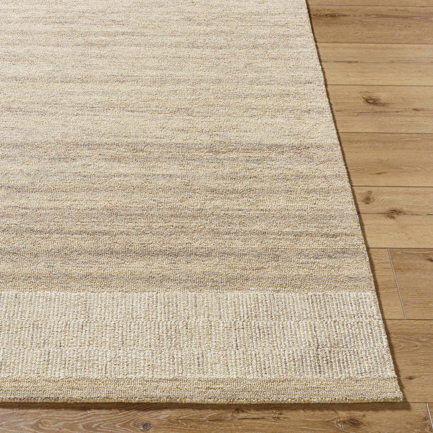 Close-up of the hand-tufted Yosef Area Rug. Prairie dust, tan, and warm gray tones with a subtle horizontal stripe pattern. Front