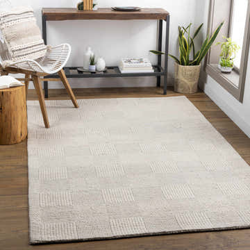 Living room scene with ivory Yarrabilba area rug, wood floors, chair, and console table. Roomscene-Rectangle
