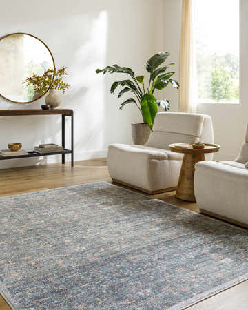 Living room scene with neutral armchairs and the Zilya Area Rug in dark brown, green, peach, and rust tones. Roomscene-Rectangle