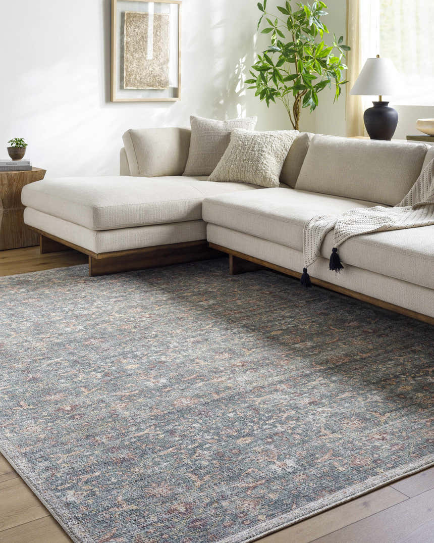Living room scene with a Zilya Area Rug in dark brown, green, peach, rust, and sage colors under a beige sectional sofa. Roomscene-Rectangle