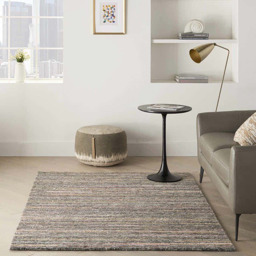 Modern living room with gray sofa and Nourison Plateau Grey Flame rug.