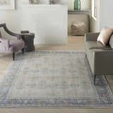 Living room scene with a grey sofa and the Nourison Starry Nights Grey Vintage Area Rug adding a touch of vintage charm.