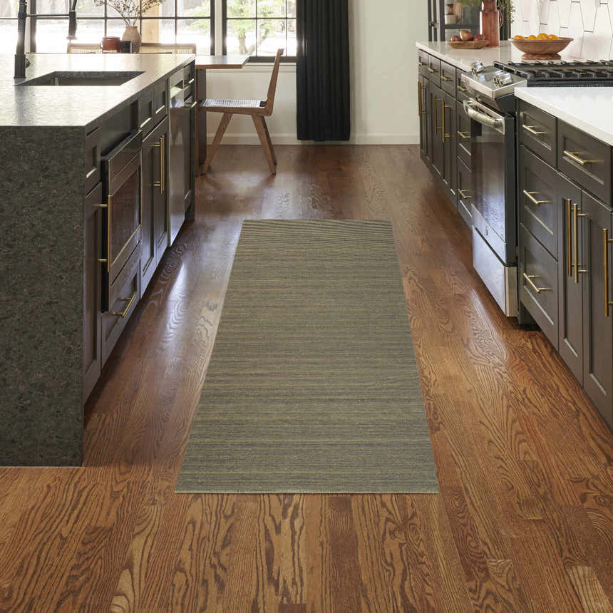 Modern kitchen with dark cabinets and Nourison Essentials Green rug runner on wood floor.