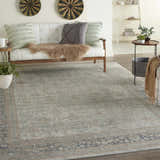 Living room scene with a Cloud Nourison Malta vintage rug, white sofa, and wood accents.