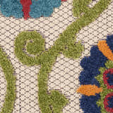 Close-up of the Nourison Aloha Blue Multicolor Rug showing floral pattern and textured, machine-made weave.