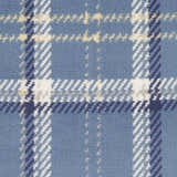 Close-up of the Nourison Grafix Blue Rustic Indoor Area Rug with a light blue, white, and navy plaid design.