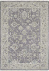 Close-up of Nourison Infinite Charcoal Vintage Indoor Area Rug with taupe floral pattern and a distressed vintage style.