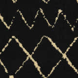 Close-up of Nourison Grafix Black Bohemian Indoor Area Rug featuring a geometric diamond pattern and plush texture.
