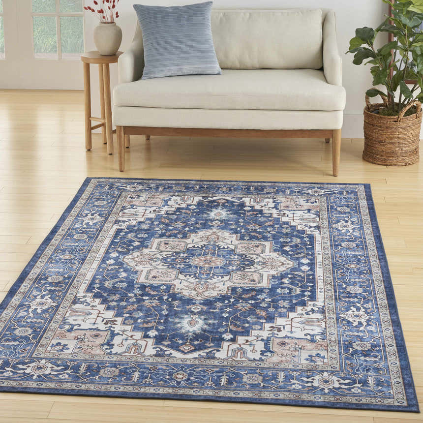 Living room scene with a Nourison Fulton Navy Ivory Vintage Area Rug, sofa, and wood floors.