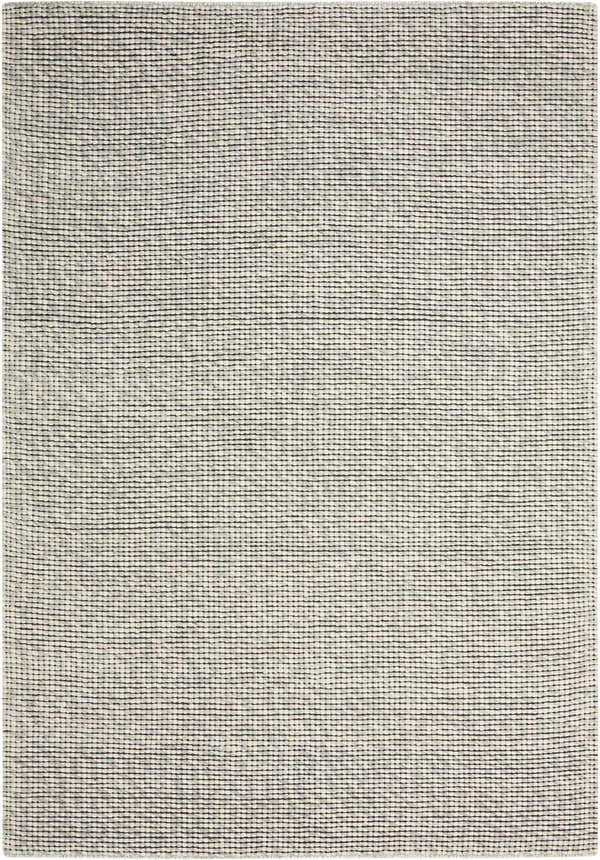 Close-up of the Calvin Klein Home Lowland Basalt rug. Handmade wool rug with a textured, horizontal striped design.