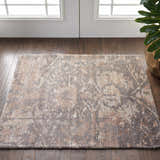 Entryway with Nourison Lucent Flint vintage rug. Bamboo silk-like rug in flint, beige, and ivory on dark wood floor.
