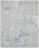 Close-up of Calvin Klein CK005 Enchanting Grey Sky rug. Contemporary high pile with blue and cream floral pattern.