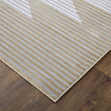 Close-up of the Feizy Marigold rug. Gold, gray, and white stripes create a modern geometric pattern. Corner