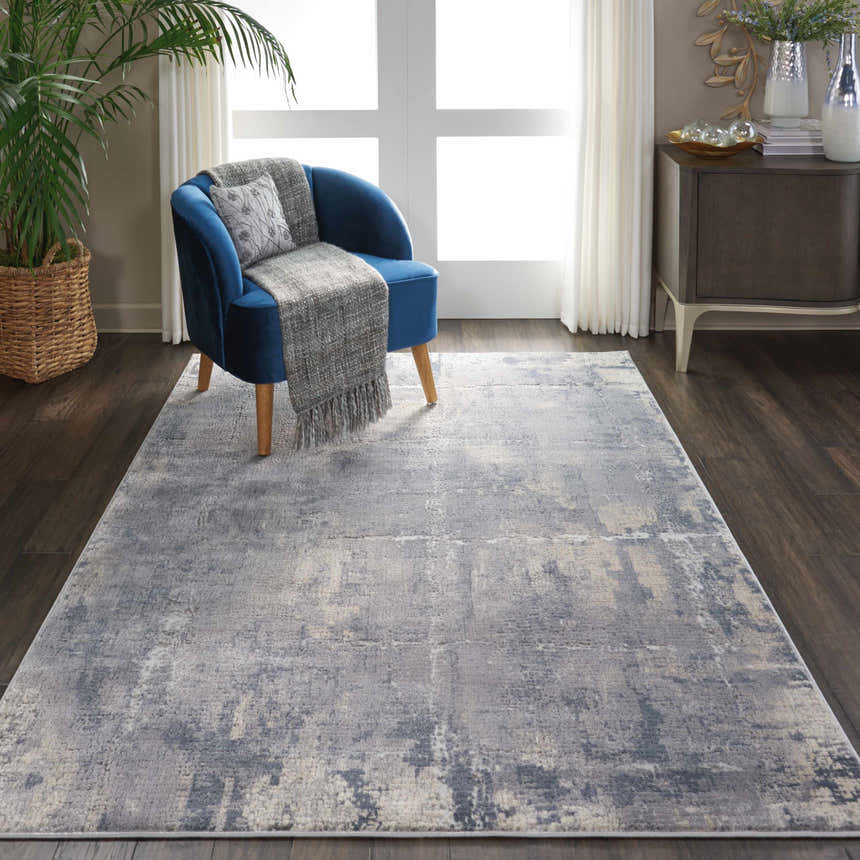 Living room scene with blue chair and grey beige Nourison Rustic Textures area rug.