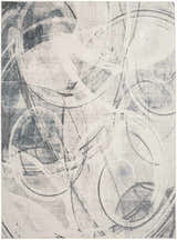 Close-up of Nourison Astra Silver Blue rug featuring a modern abstract circle pattern in gray, blue, and white.