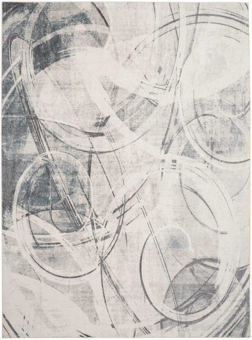 Close-up of Nourison Astra Silver Blue rug featuring a modern abstract circle pattern in gray, blue, and white.