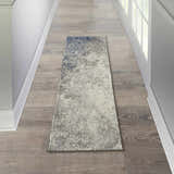 Hallway scene with Nourison Passion Charcoal Ivory rug runner on wood floor, white walls and door.