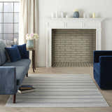 Living room with blue velvet furniture and Nourison Key Largo Blue Contemporary Area Rug on light wood floors.