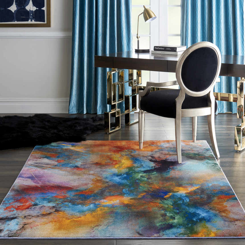 Modern office with Nourison Le Reve Multicolor rug, dark desk, silver chair, and blue curtains.