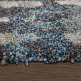 Close up of Feizy Skyview rug shows abstract gray, black, ivory and blue pattern and soft, textured pile. Pile