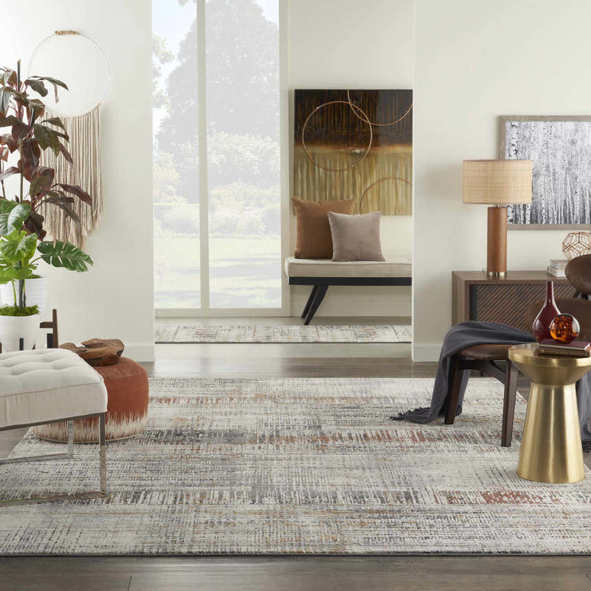 Living room scene with a Nourison Tangra Multicolor rug, neutral furniture, and modern decor.