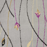 Close-up of the Nourison Grafix Grey Rug featuring a floral design with purple, gold, and black accents.