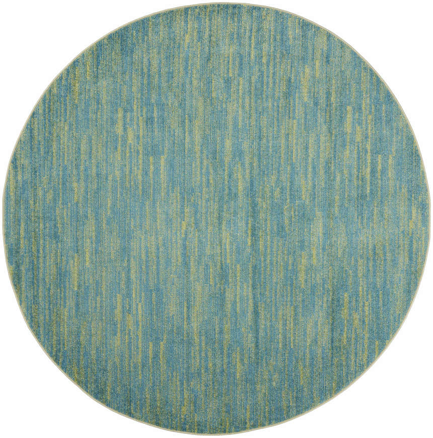 Close-up of a round Nourison Essentials Blue Green Outdoor Area Rug with a textured blue and green pattern.