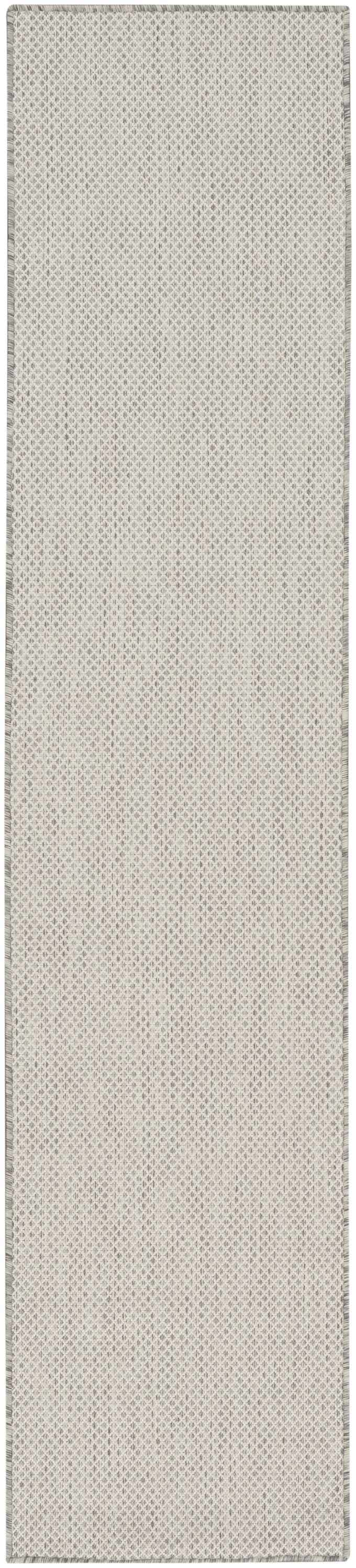 Close-up of the Nourison Courtyard Ivory Silver rug. Shows a subtle diamond pattern and woven texture.