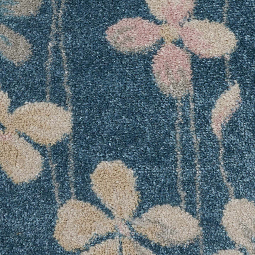Close-up of the Nourison Tranquil Turquoise rug. Aqua background with beige and pink floral pattern. Contemporary style.