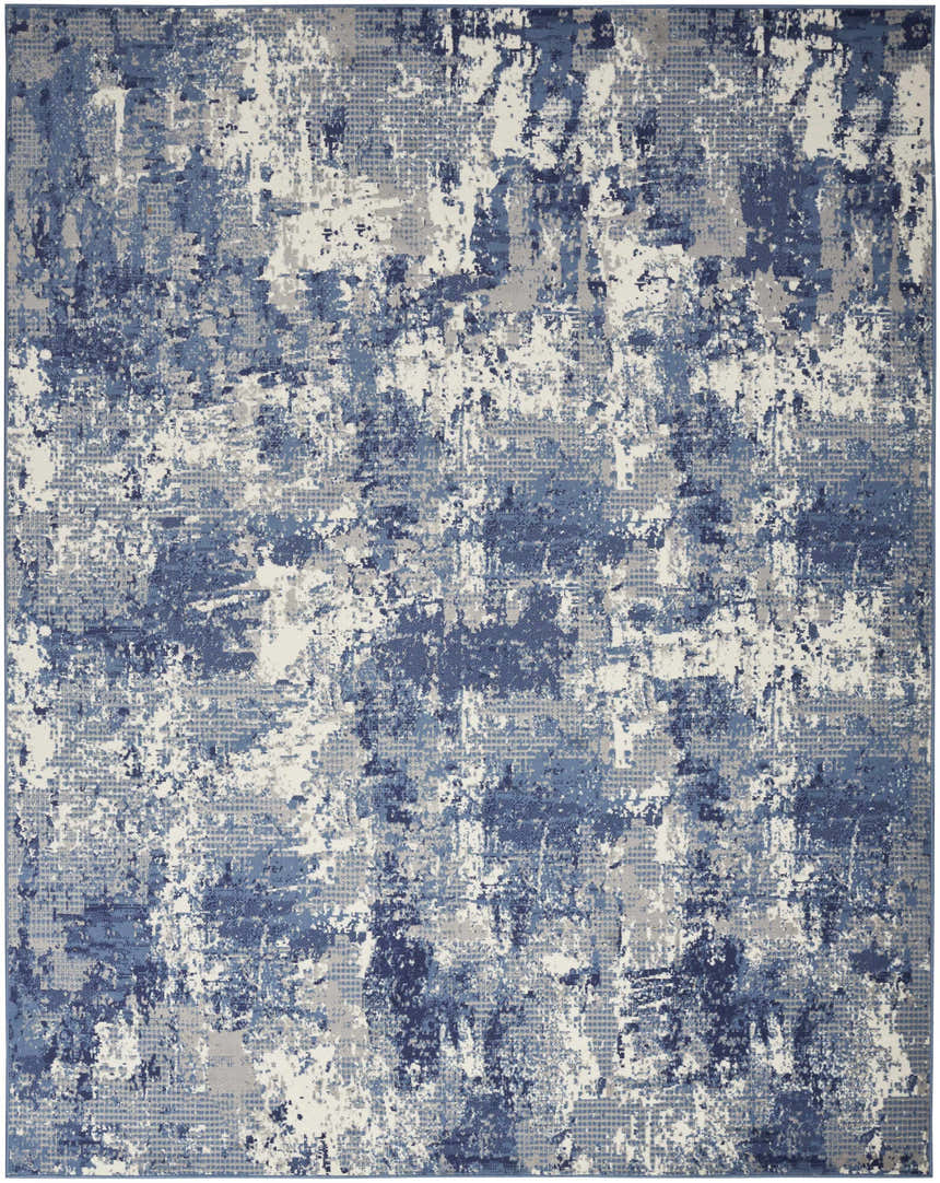 Close-up of the Nourison Grafix Navy Blue rug. Features an abstract pattern in shades of navy, blue, gray, and white.