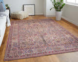 Living room scene with Feizy Rawlins rug in red, tan, and pink. Transitional style with sofa, pouf, wood floors, and plant. Roomscene-Rectangle