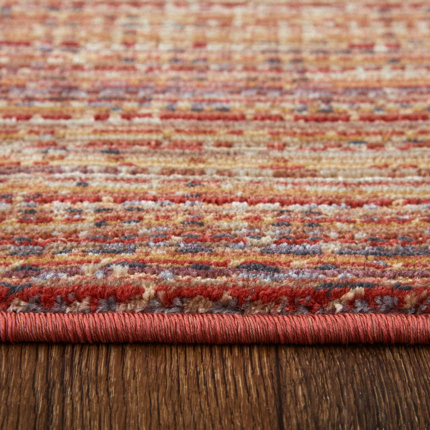 Close-up of Feizy Deja Modern Solid rug showing brown, red, and tan colors and textured weave. Pile
