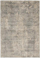 Close-up of the Nourison Quarry Beige Gray rug. Features a distressed, abstract design in beige, gray, and brown tones.