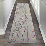 Hallway with Nourison Grafix Grey Contemporary Indoor Area Rug runner. Floral design in grey, purple, and gold.