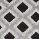 Close-up of the Nourison Aloha Black White Modern Area Rug featuring a geometric diamond pattern and textured weave.