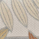 Close-up of the Nourison Aloha Blue Mocha Outdoor Area Rug, showing the leaf pattern and textured weave.