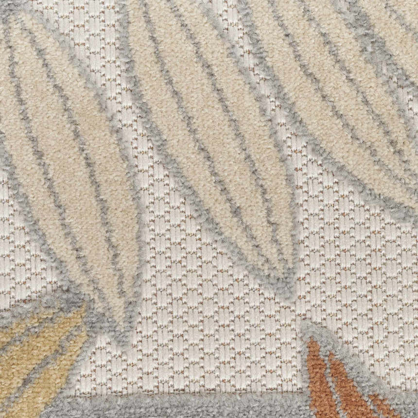 Close-up of the Nourison Aloha Blue Mocha Outdoor Area Rug, showing the leaf pattern and textured weave.