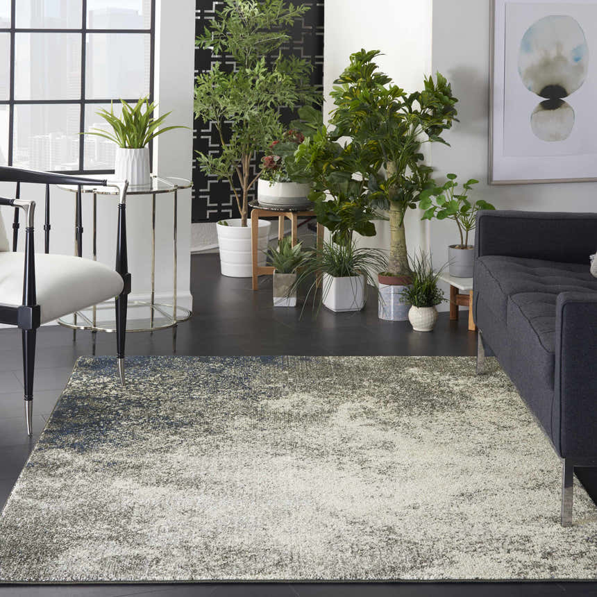 Modern living room with charcoal sofa and Nourison Passion Charcoal Ivory area rug.