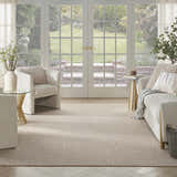 Light-filled living room with a Nourison Courtyard Jute Ivory Modern Area Rug, neutral furniture, and garden view.