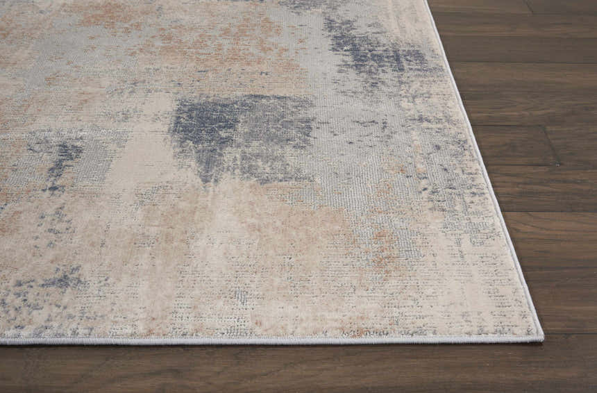 Close up of Nourison Rustic Textures Beige Grey rug showing abstract pattern and soft beige, gray, and blue tones.