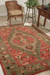 Traditional living room scene with a Nourison Tahoe Rust area rug, wood chair, and accent table.
