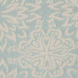 Close-up of the Nourison Jubilant rug in ivory and green. Farmhouse style, with a detailed floral pattern.