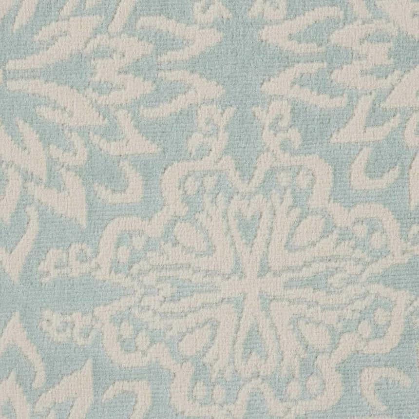 Close-up of the Nourison Jubilant rug in ivory and green. Farmhouse style, with a detailed floral pattern.